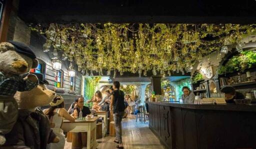 Cozy restaurant interior with hanging lights and patrons