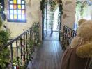 Arched hallway with wooden flooring and decorated with plants