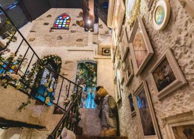 Decorative indoor stairway with art and stained glass windows