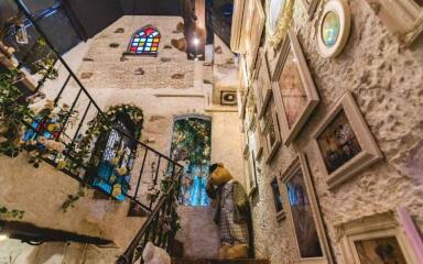 Decorative indoor stairway with art and stained glass windows