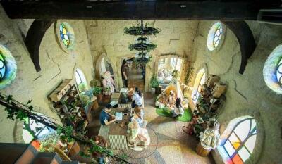 Spacious and uniquely designed living room with high ceilings and stained glass windows