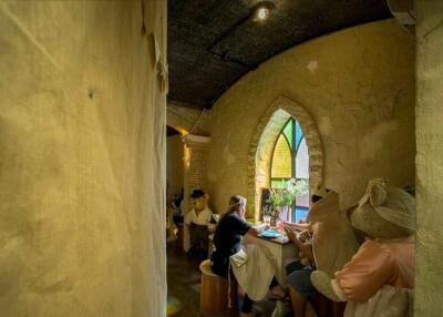 Rustic dining area with arched stained glass window