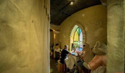 Rustic dining area with arched stained glass window