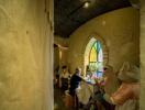 Rustic dining area with arched stained glass window