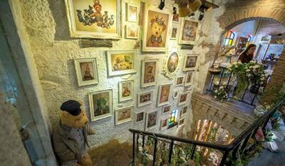 Decorated stairwell with framed artwork and stuffed animals