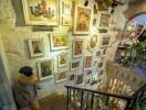 Decorated stairwell with framed artwork and stuffed animals