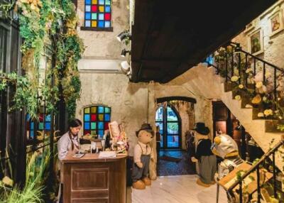 Lobby area with colorful stained glass windows and plush toys