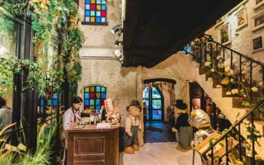 Lobby area with colorful stained glass windows and plush toys