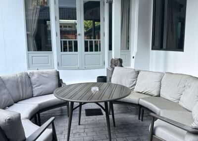 Patio seating area with round table and cushioned chairs