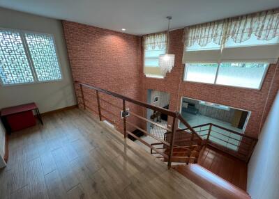 Staircase with wooden floor and railing