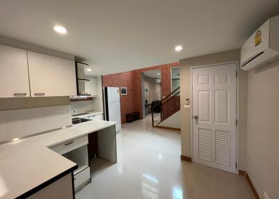 Modern kitchen with adjacent dining and living area