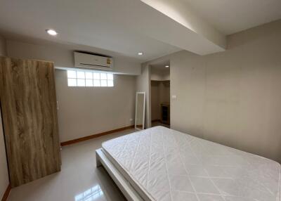 Spacious bedroom with bed and wardrobe