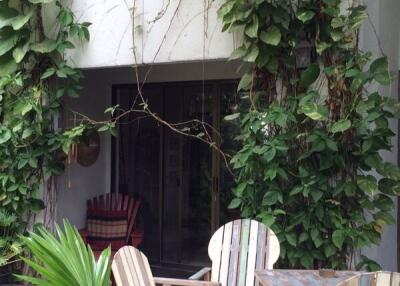 Outdoor patio with furniture and greenery