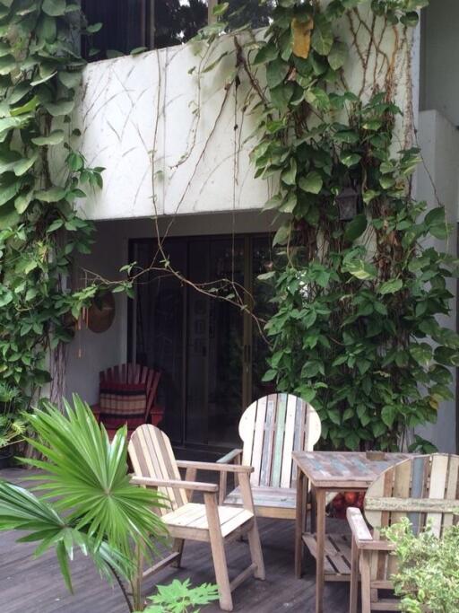 Outdoor patio with furniture and greenery