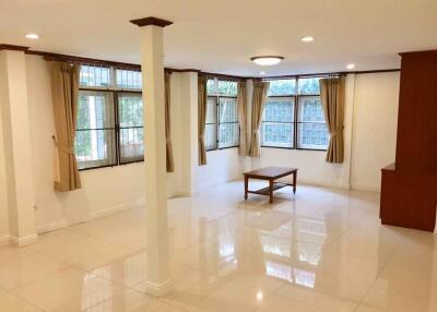 Spacious living room with large windows and natural light