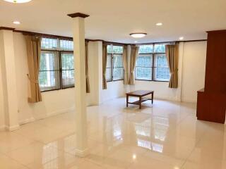 Spacious living room with large windows and natural light