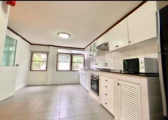 Bright, modern kitchen with multiple cabinets and appliances