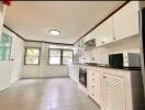 Bright, modern kitchen with multiple cabinets and appliances