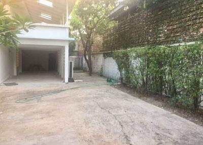 Spacious garage area with attached garden