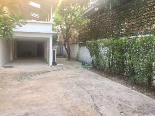 Spacious garage area with attached garden