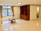 Spacious living room with built-in shelving and natural light