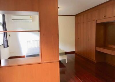 Spacious bedroom with wooden wardrobes and air conditioning