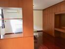 Spacious bedroom with wooden wardrobes and air conditioning