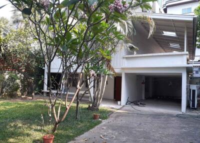 Exterior of a residential property with a garden and covered garage