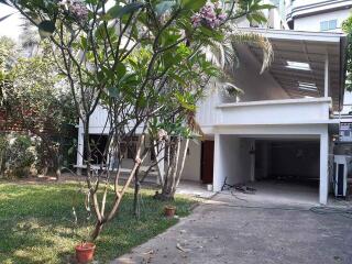 Exterior of a residential property with a garden and covered garage