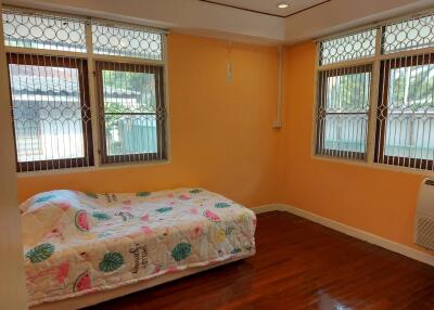 Bedroom with wooden floor and cozy bed