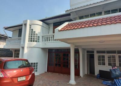 Front view of a residential building with car parked in the driveway