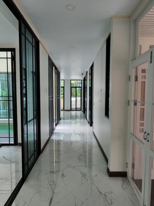 Spacious marble-floored hallway with glass doors