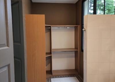 Walk-in closet area with tiled flooring and shelving