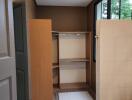 Walk-in closet area with tiled flooring and shelving