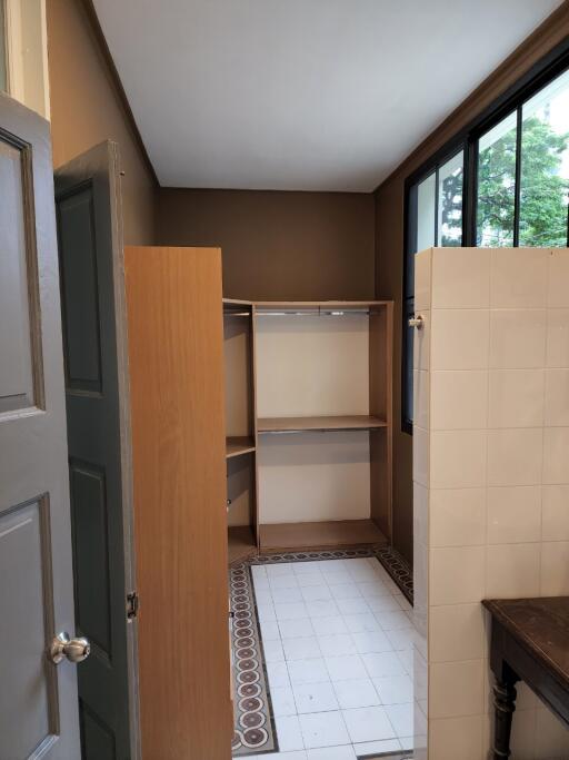 Walk-in closet area with tiled flooring and shelving