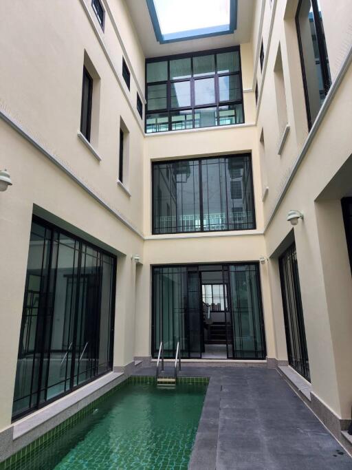 Modern courtyard with pool and glass windows