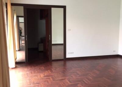 Bedroom with wooden floors and large window