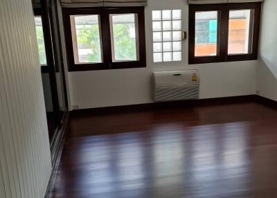 spacious living room with wooden flooring and large windows