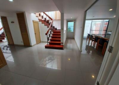 Spacious main living area with staircase and adjoining dining area