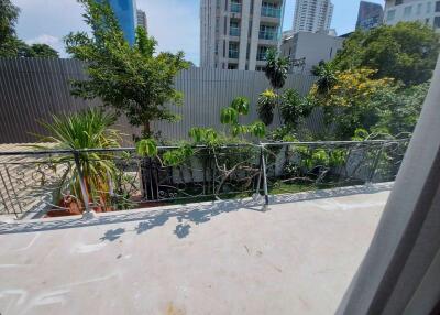 Balcony view with greenery and cityscape