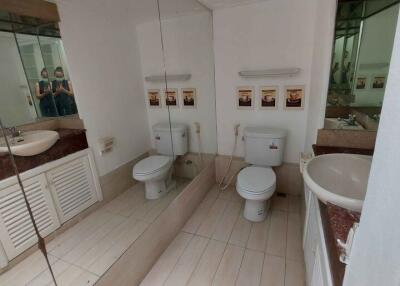 modern bathroom with two sinks and toilets