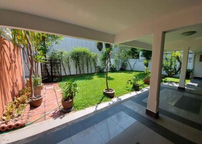 Covered patio area with view of garden