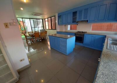 Modern kitchen with blue cabinetry and attached dining area