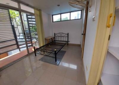 Empty bedroom with bed frame and large window