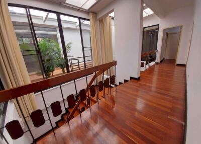 Bright hallway with wooden floors and large windows