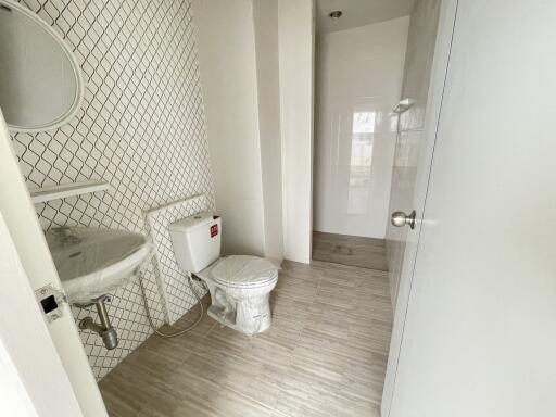 Modern bathroom with sink, toilet, and shower