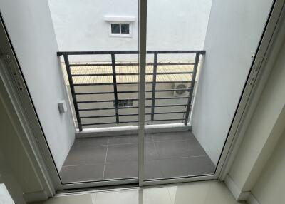 Small balcony with sliding glass doors and metal railing