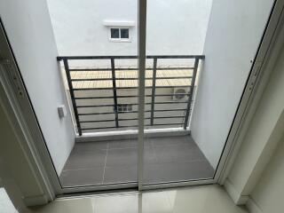 Small balcony with sliding glass doors and metal railing