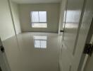 Empty bedroom with white walls and a window