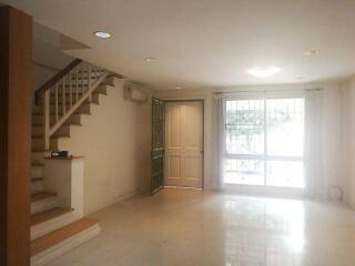 Spacious living room with access to stairs